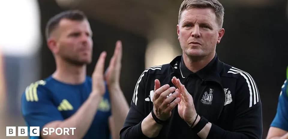 Coach applauding during a match with staff behind