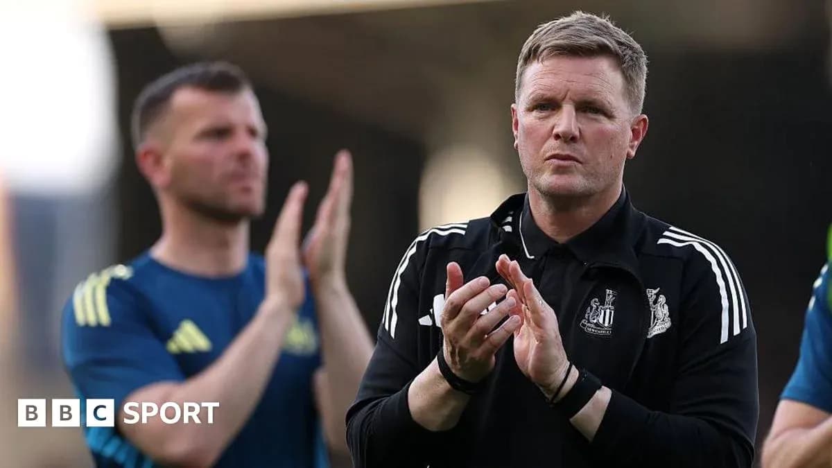 Coach applauding during a match with staff behind