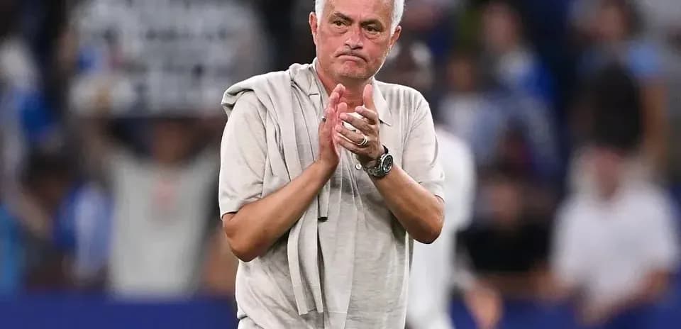 Coach clapping towards fans after the match