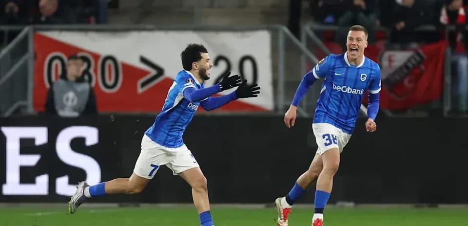 Two players celebrating a goal on the field