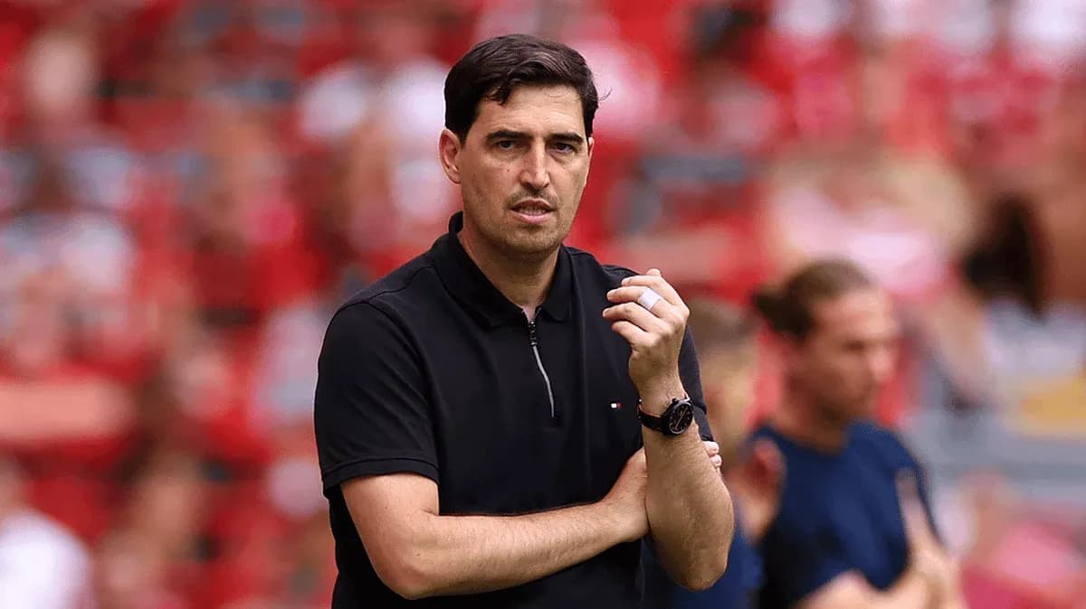 Coach observing match with crossed arms on sidelines