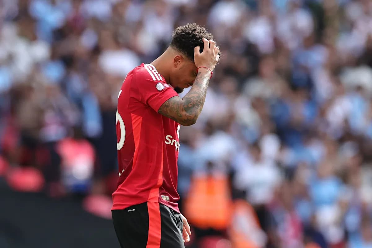 Player in red jersey holding head during match