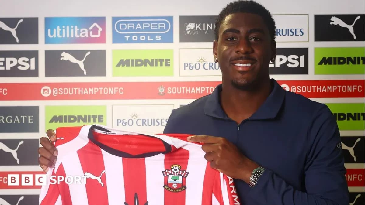 Player holding Southampton FC jersey at press conference