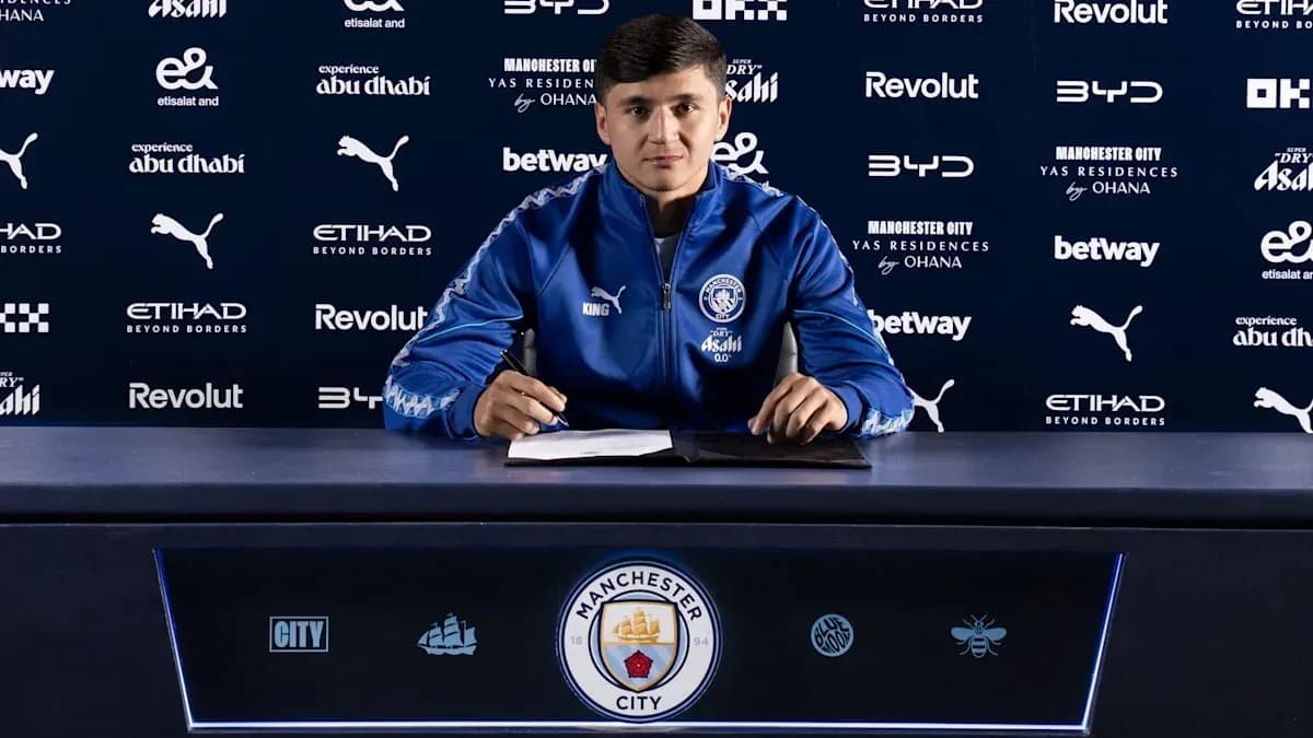 Player signing contract at Manchester City press conference