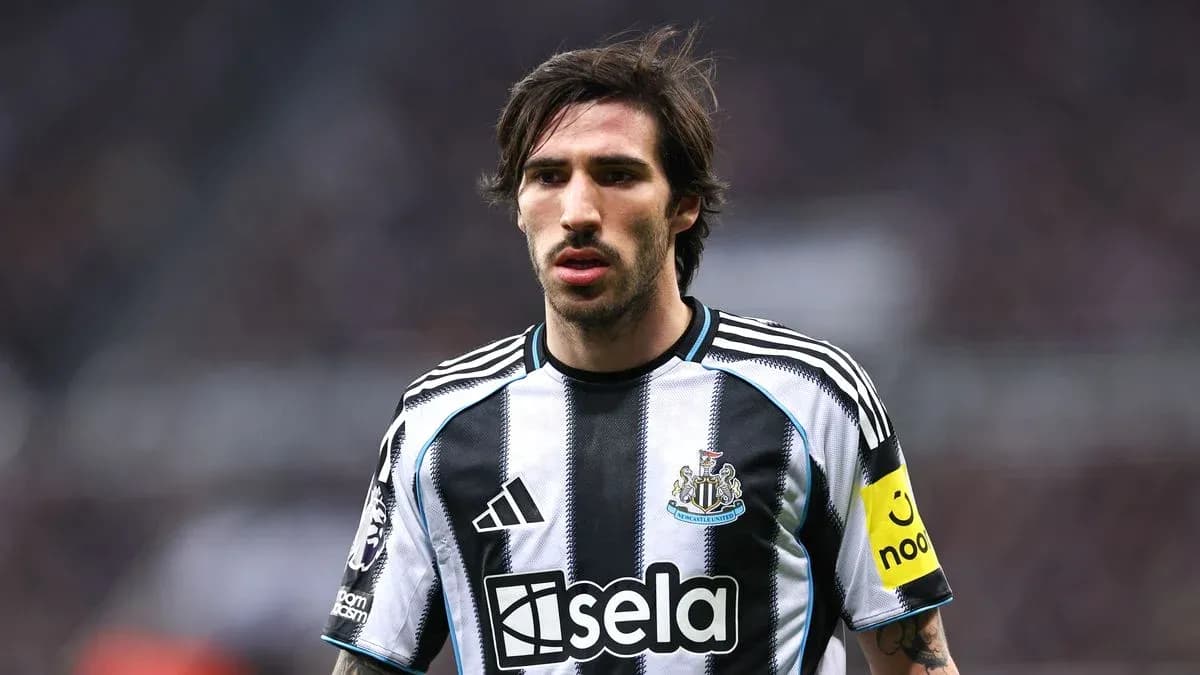 Player wearing Newcastle United jersey on the pitch