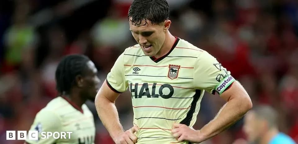 Player looking down in disappointment on the pitch