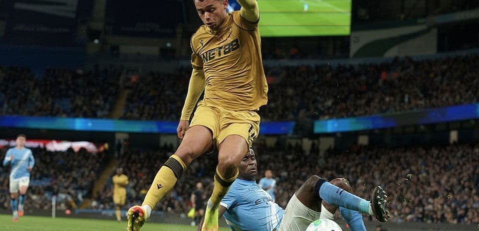 Player tackling during Manchester City match