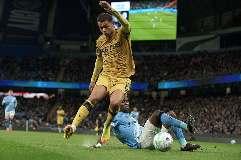 Player tackling during Manchester City match