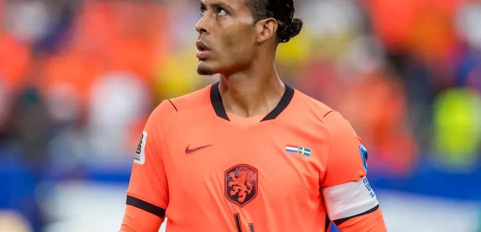Player in orange jersey looking upwards on field