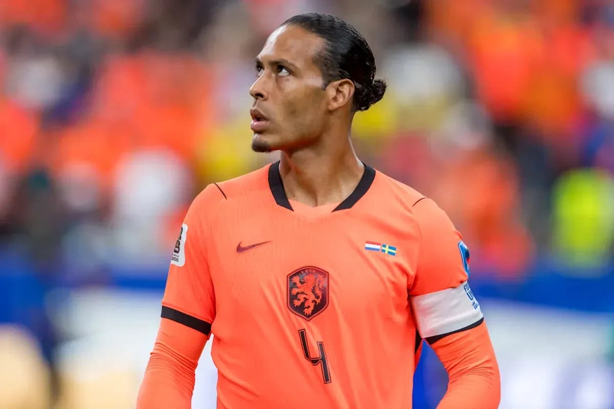 Player in orange jersey looking upwards on field