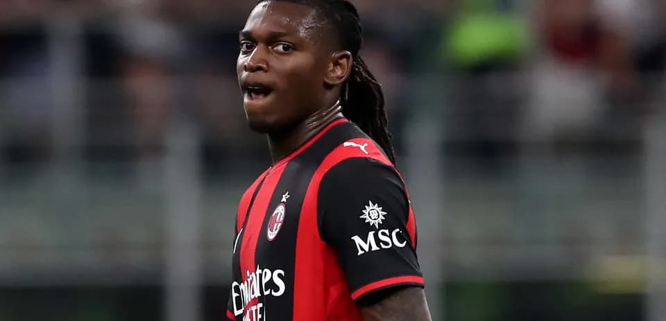 AC Milan player in red and black jersey during match