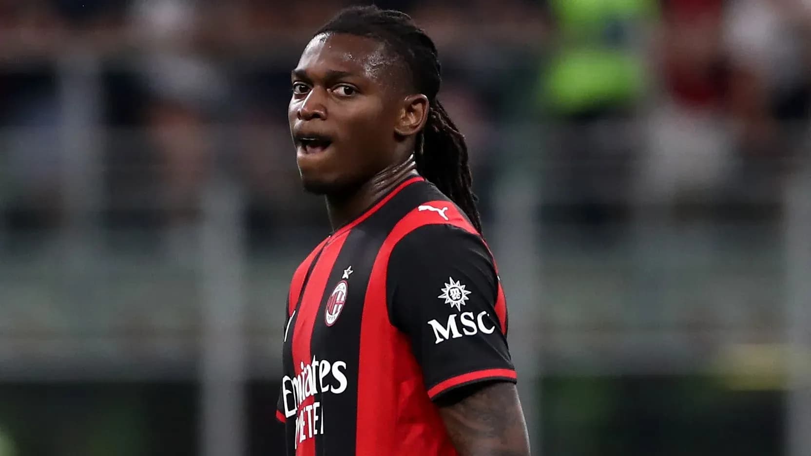 AC Milan player in red and black jersey during match