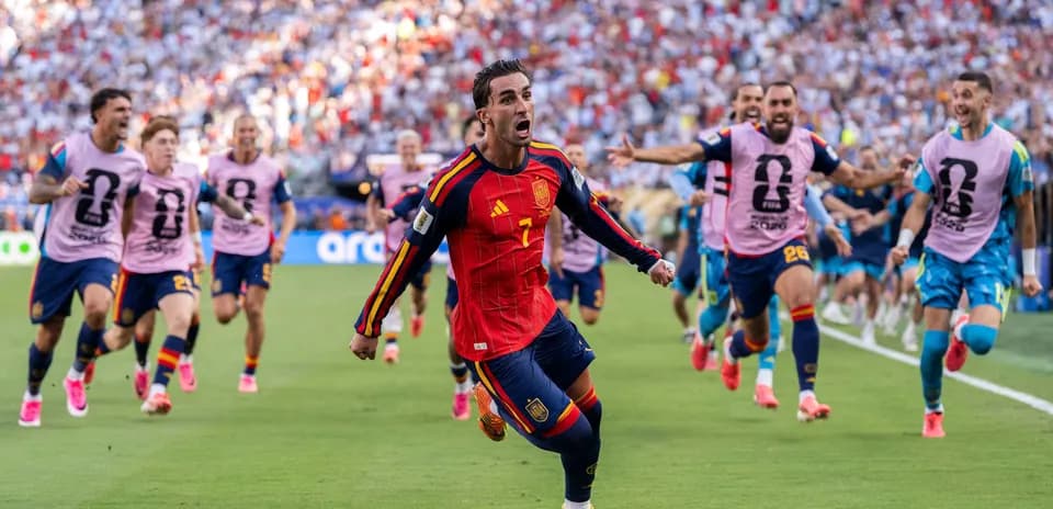 Spain player celebrating goal with teammates in match
