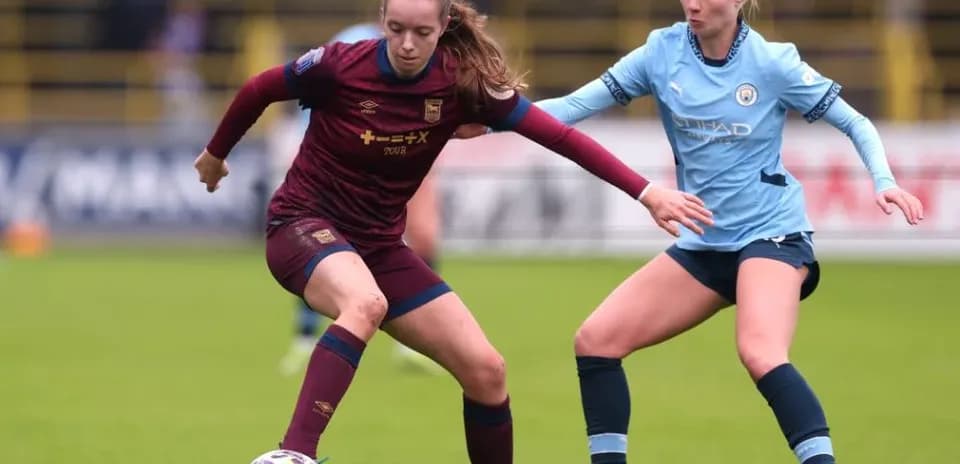 Two players contesting for the ball during match