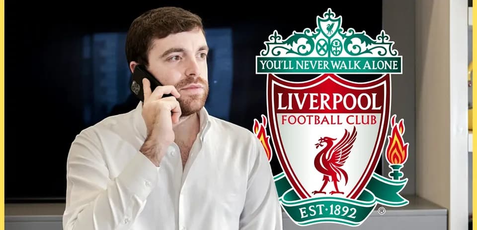 Person on phone with Liverpool FC logo in background