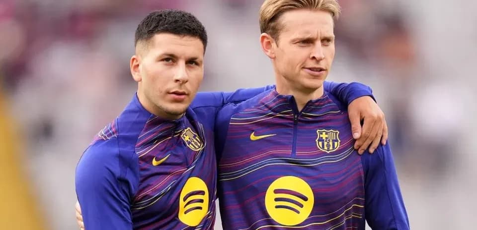 Two players in Barcelona training kits embracing