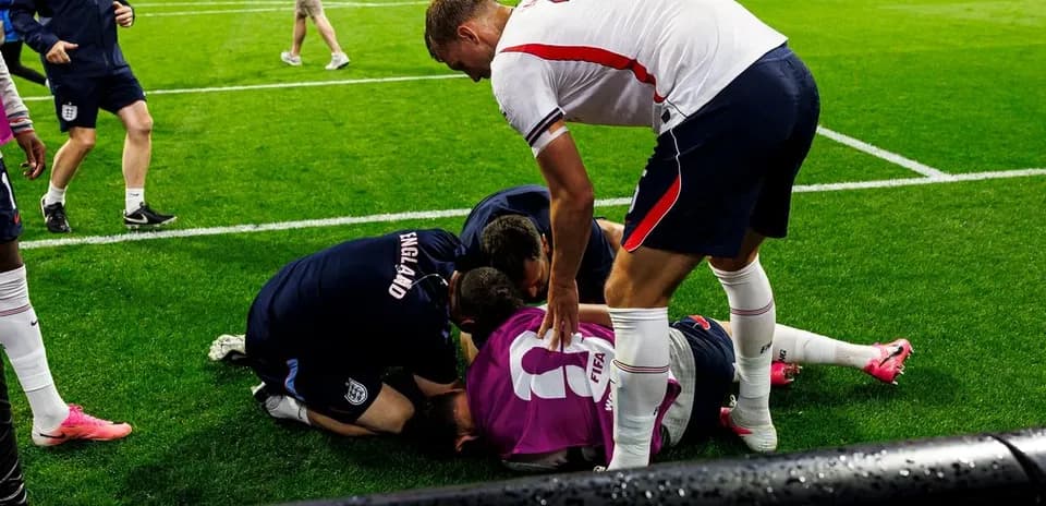 Players attending to an injured teammate on the field