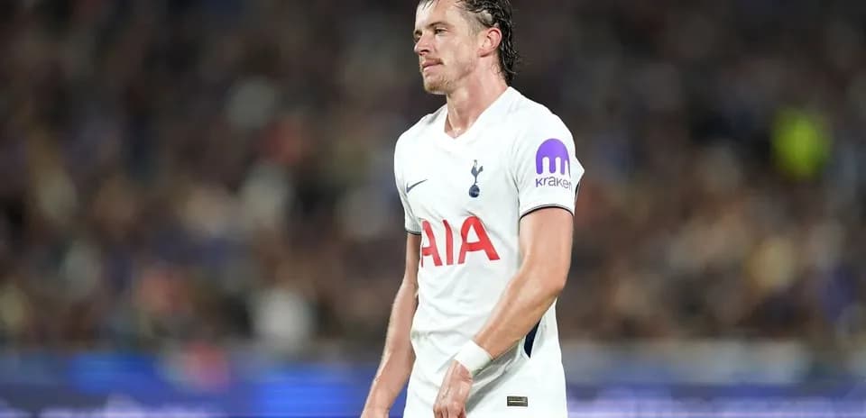 Tottenham player walking on field during match