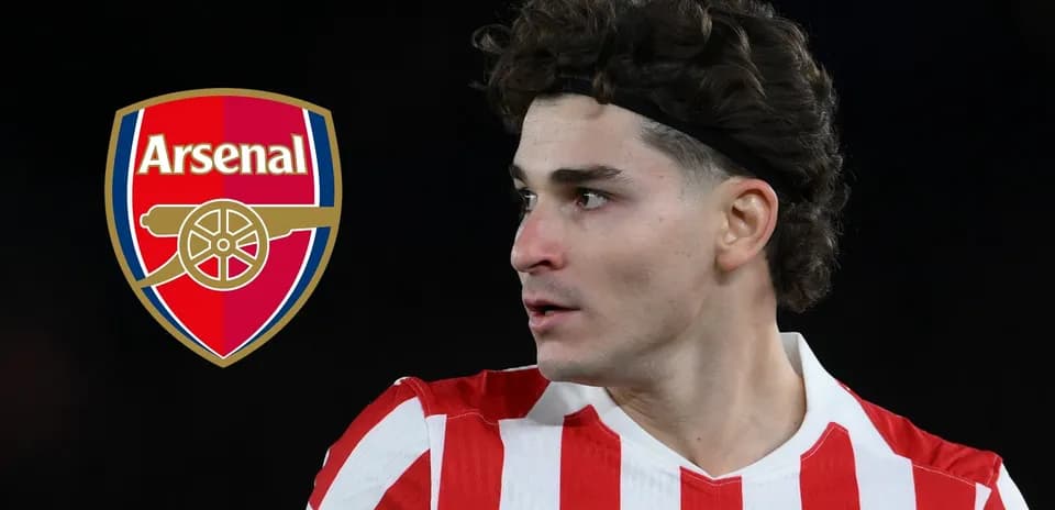 Player in red and white stripes near Arsenal logo