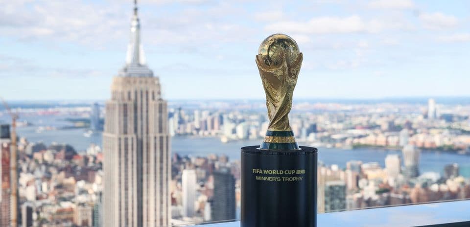 FIFA World Cup trophy with city skyline backdrop