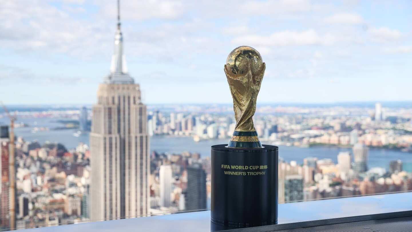 FIFA World Cup trophy with city skyline backdrop