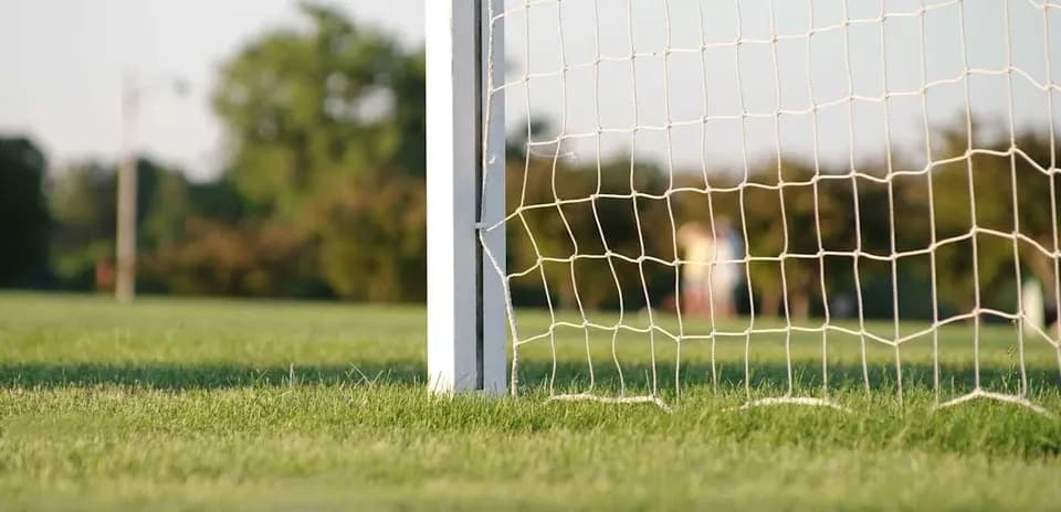 Close-up of soccer goal net on field