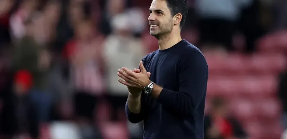 Manager clapping and acknowledging fans after match