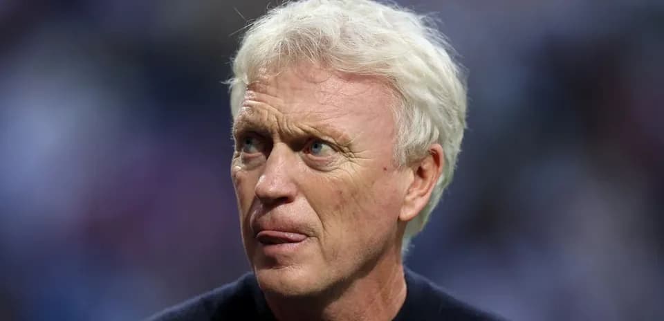 Football manager observing the match from the sidelines