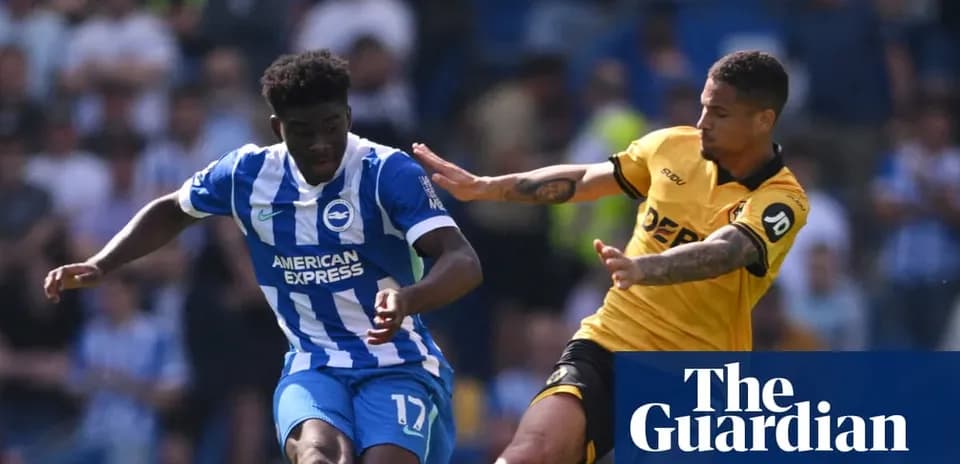 Player dribbling past opponent during football match
