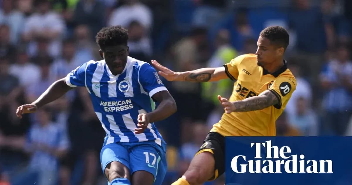 Player dribbling past opponent during football match