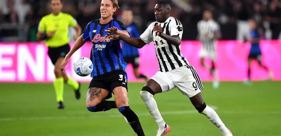 Two players competing for the ball in match