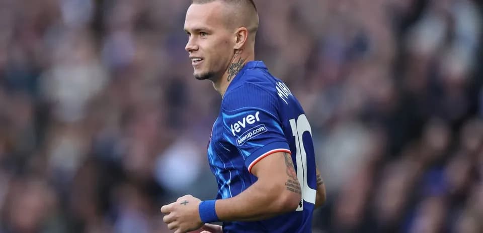 Player wearing blue jersey during match celebration