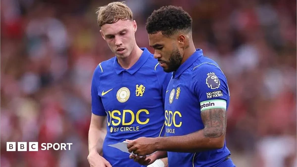 Two Chelsea players discussing strategy during match