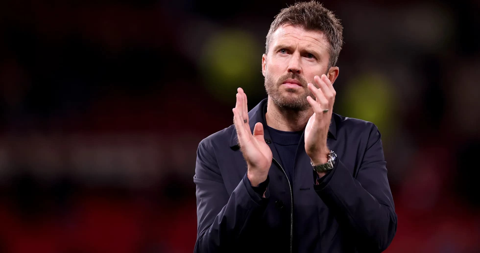 Man applauding on the pitch after a match