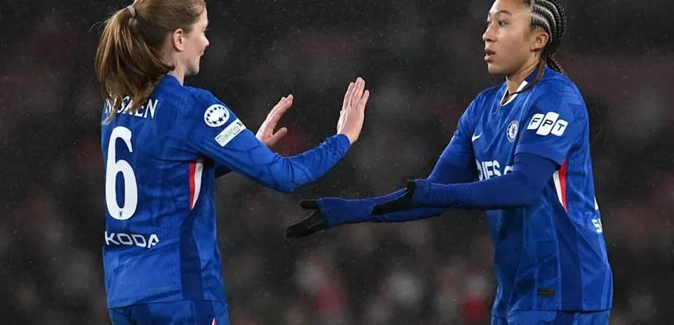 Two Chelsea players exchanging gestures on the field