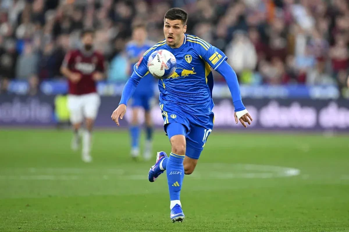 Player in blue kit dribbling the ball during match