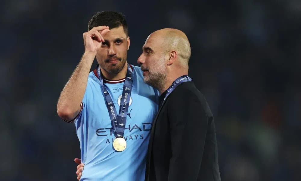 Player and manager celebrating post-match with medals