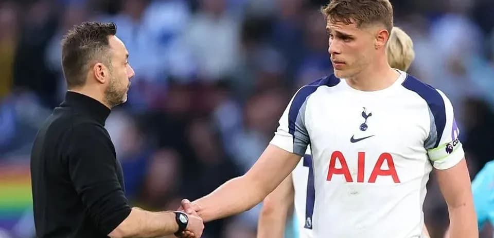 Manager and player shaking hands on the pitch