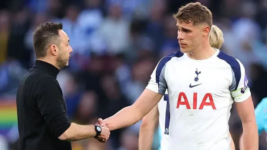Manager and player shaking hands on the pitch