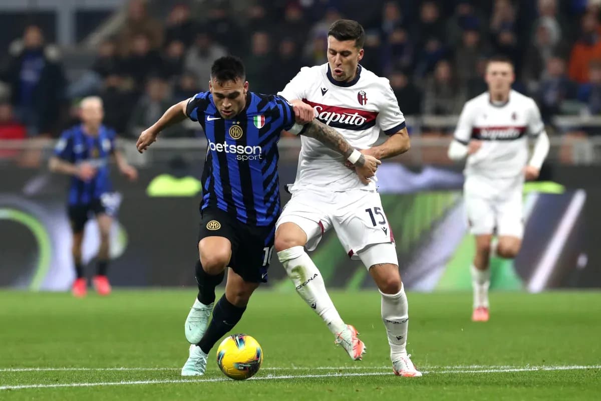 Inter player dribbling past Bologna defender