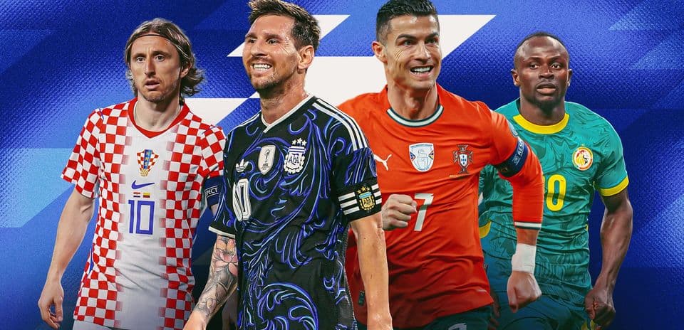 Four football players in team jerseys posing together