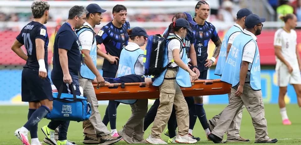 Medical team transporting injured player on stretcher
