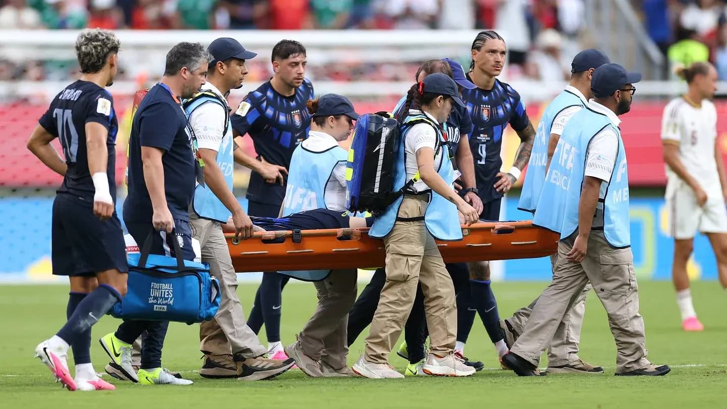 Medical team transporting injured player on stretcher