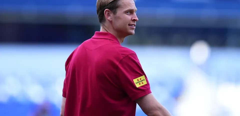 Coach wearing red shirt on the field