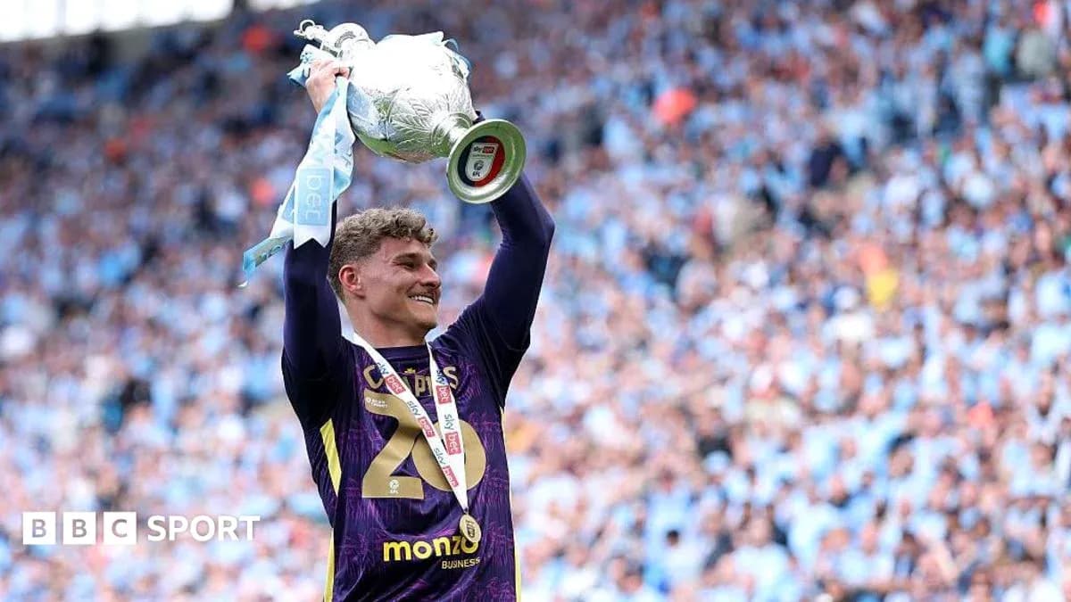 Player celebrating with trophy at stadium
