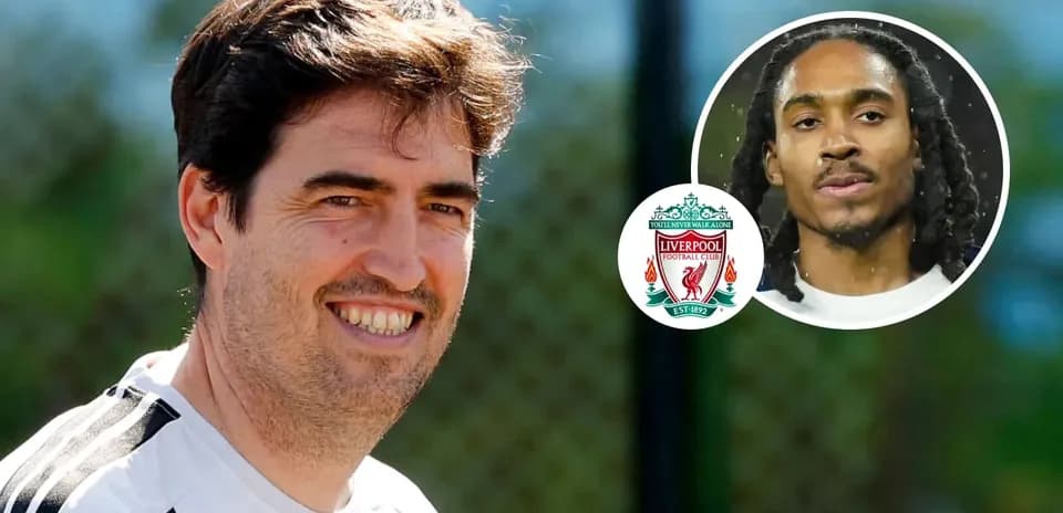 Coach smiling during training session with Liverpool logo