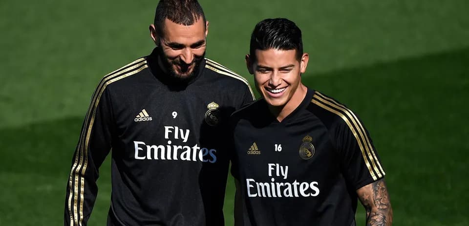 Two Real Madrid players smiling during training session