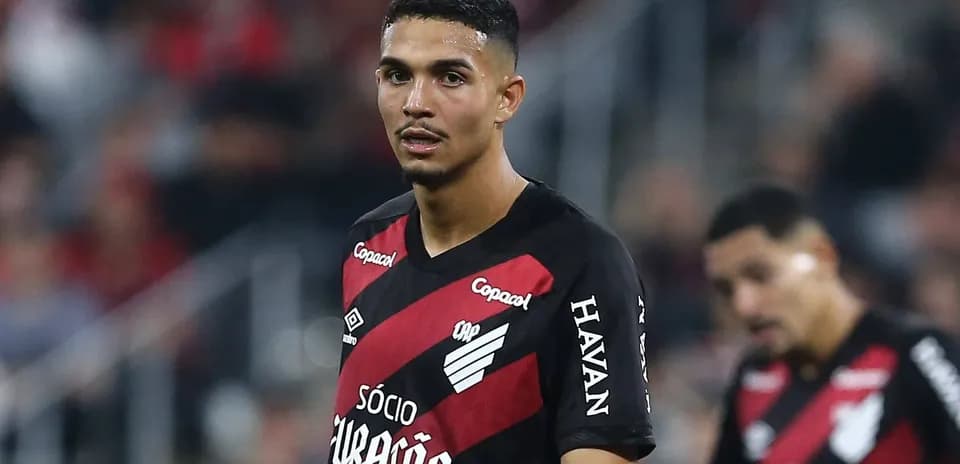 Player wearing red and black jersey during match