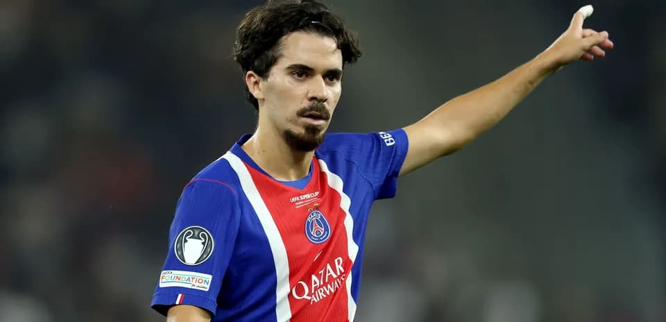 Player gesturing during a match wearing PSG jersey