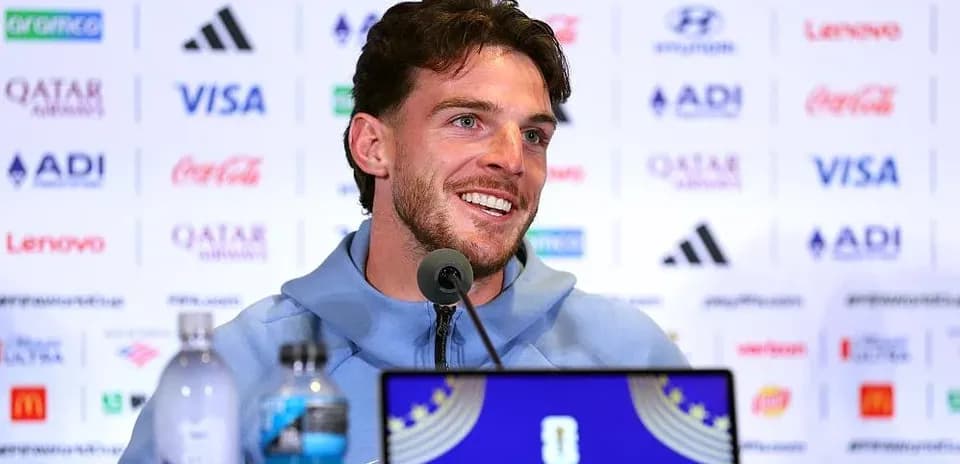 Player speaking at press conference with sponsors' logos